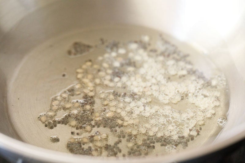 urad dal and mustard seeds in the wok or kadai.