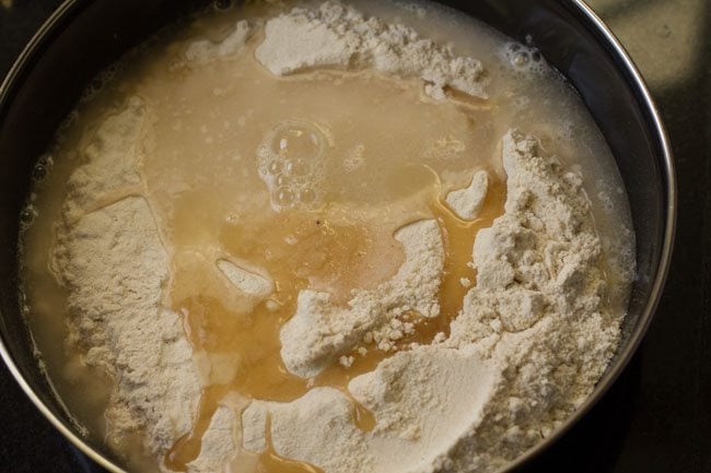 oil and water added to mixing bowl with flour.