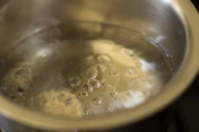boiling water for cooking potatoes for dum aloo recipe. 