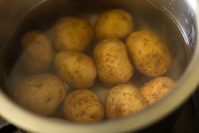 cooking potatoes for dum aloo recipe. 