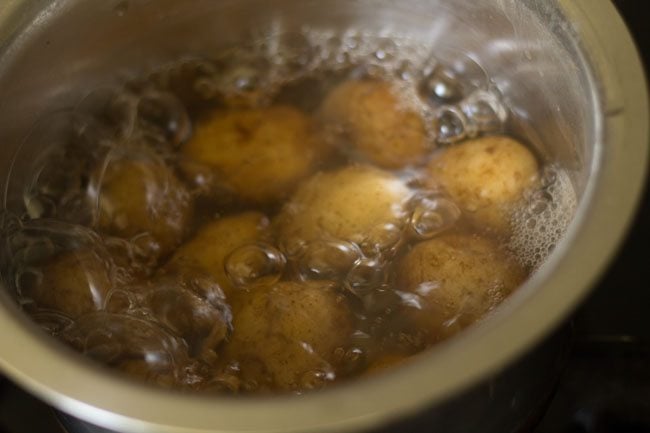 boiling potatoes for dum aloo recipe. 