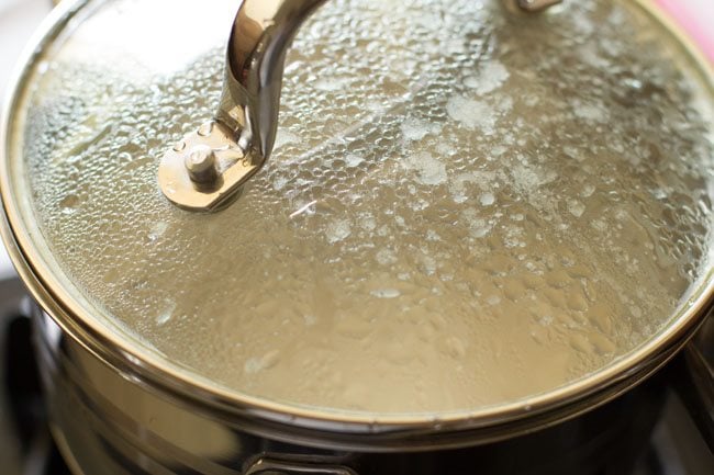 cooking paste in covered pan for making dum aloo. 