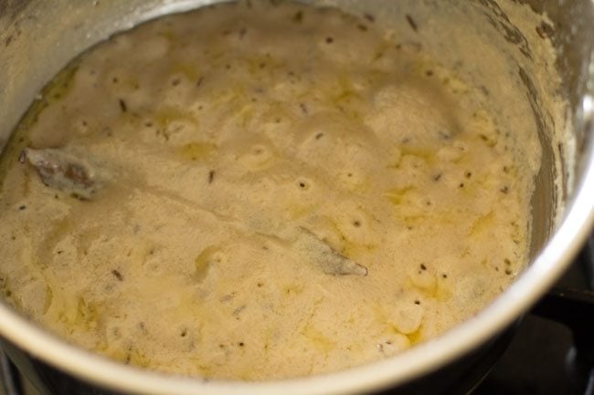 sautéing the paste for dum aloo. 