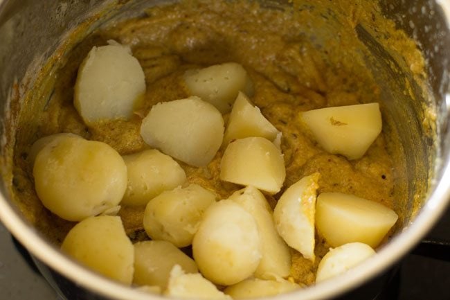 cooked potatoes added in the masala paste. 
