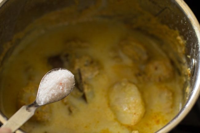 adding salt to dum aloo. 