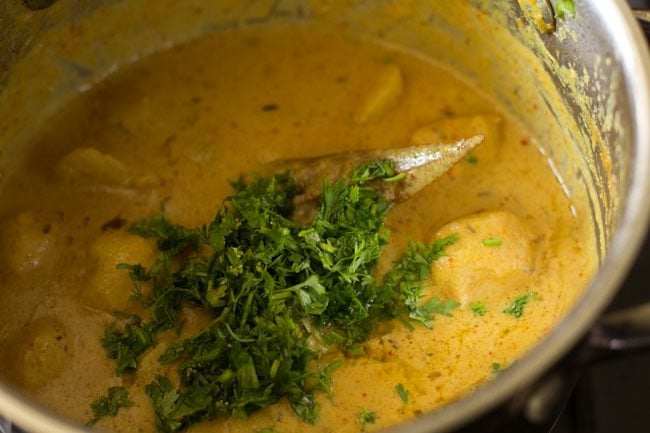 chopped coriander leaves added to cooked dum aloo. 
