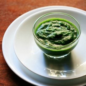 green chutney in glass bowl on two white plates.