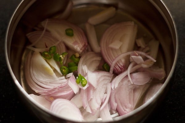 sliced onions and chopped green chilies in a bowl. 