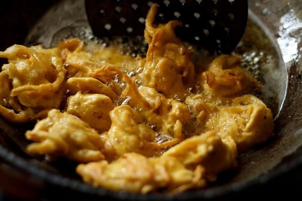 frying onion pakoda in hot oil. 