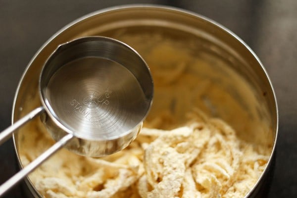 adding water to onion-gram flour mixture. 