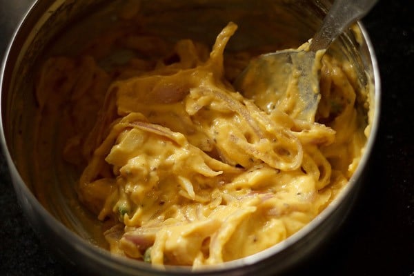 onion pakoda batter in a bowl. 