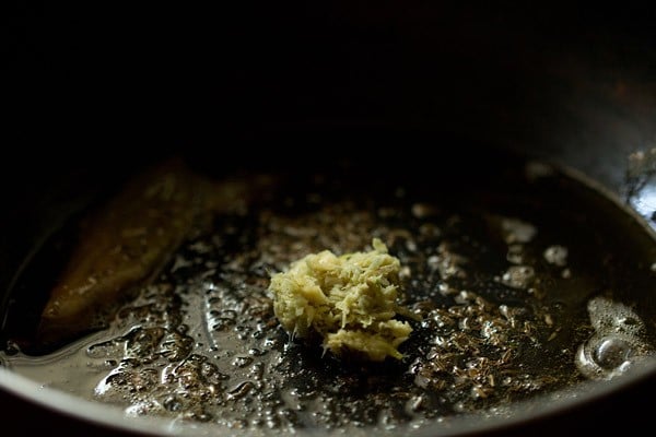 ginger paste added to pan with spices and oil