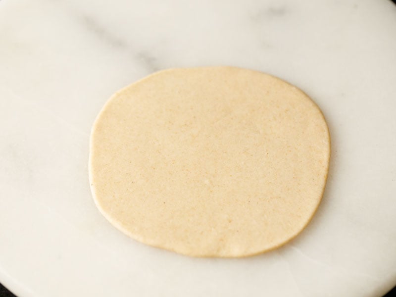 dough that's been flattened rolled into a circle