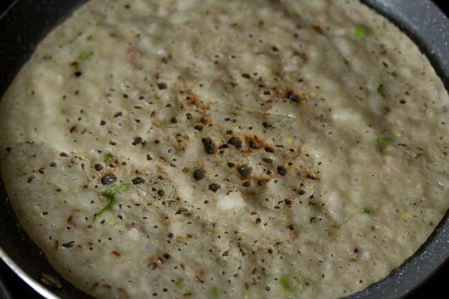 The bottom of suji ka dosa has become crisp and golden