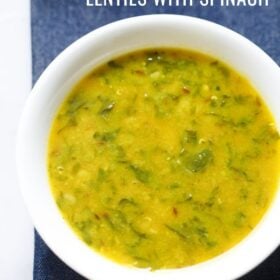 dal palak served in a white bowl on a dark blue napkin with text layovers.